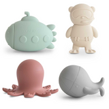 Set of four silicone bath toys shaped like a submarine, diver, octopus, and whale on a white background.
