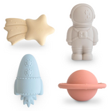 Set of four silicone bath toys shaped like a star, astronaut, rocket, and planet on a white background.