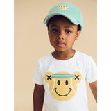 Boy wearing HUXBABY Tennis Bear T-Shirt and matching cap