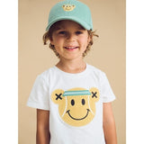 Boy wearing HUXBABY Tennis Bear Cap and Tennis Bear tee - studio shot