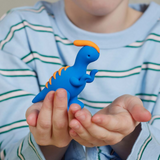 Child holding a blue dinosaur clay toy