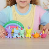 Child playing with colorful unicorn toys on a table