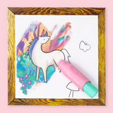 Colorful unicorn drawing with a pink water paint brush on a white sheet, framed in gold with a pink background.