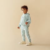 Side view of child wearing WILSON & FRENCHY Sage Organic Terry Hooded Sweat & matching trackpant