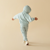 Back view of child wearing WILSON & FRENCHY Sage Organic Terry Hooded Sweat and matching sweat pant