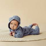Baby lying face down on floor wearing WILSON & FRENCHY Sky Blue Organic Quilted Jacket and matching pant