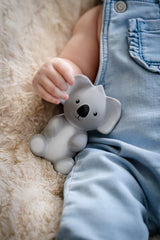 Baby holding ear of TIKIRI Rubber Koala Australian Animal