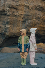 Kids outside wearing CRYWOLF Explorer Jacket - Pink Colourblock and Fern Colourblock with Rain overalls and Rain boots