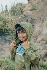 Child wearing hood up on the CRYWOLF Play Jacket - Catapult and fern rain overalls underneath