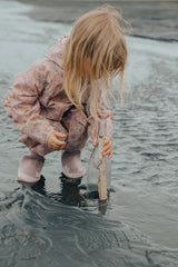 Girl playing in water at beach wearing CRYWOLF Splash Suit - Daisy Floral