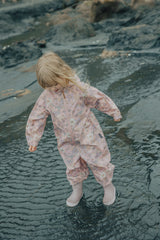 Girl playing in water at beach wearing CRYWOLF Splash Suit - Daisy Floral