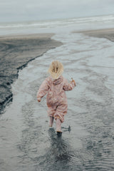 Back view of girl wearing CRYWOLF Splash Suit - Daisy Floral at the beach