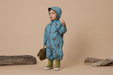 Studio shot of Toddler wearing CRYWOLF Splash Suit - Stone Blue with hood up and Fern gumboots on the feet