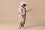 Side view of girl wearing CRYWOLF Splash Suit - Daisy Floral and Mauve rain boots