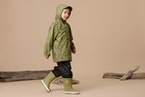 Side shot of child wearing CRYWOLF Play Jacket - Catapult and matching fern rainboots