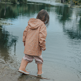 Back view of child wearing CRYWOLF Play Jacket Rain Drops, Dusty Pink Rain Overalls and Terracotta Rain Boots