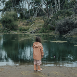 Back view of child wearing CRYWOLF Play Jacket Rain Drops, Dusty Pink Rain Overalls and Terracotta Rain Boots