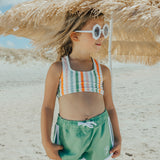 Girl wearing CRYWOLF Surf Short - Coastal Green and Summer Stripe bikini top