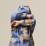 Child with arms folded over eyes wearing the CRYWOLF Play Jacket Camo Mountain