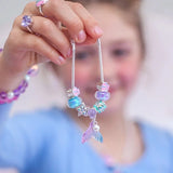 Child holding LAUREN HINKLEY Mermaid's Tail Charm Bracelet