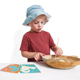 Child playing with the JANOD Dino Dig Game