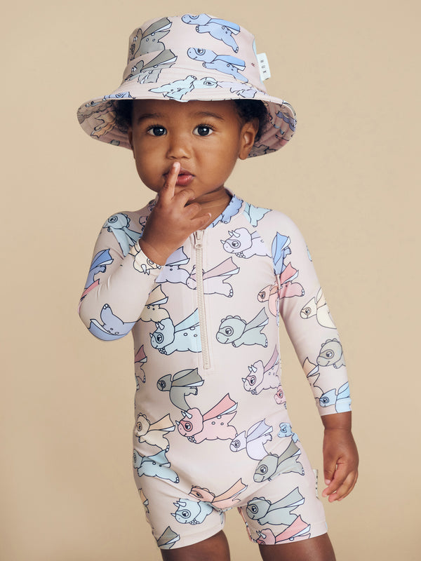 Child wearing the HUXBABY Super Dino Swim Hat and matching swimwuit