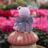 Garden shot of back of the OLLI ELLA Dinky Dinkum Dolls - Betty Butterfly - Purple sitting on a mushroom can basket