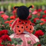 Back view of OLLI ELLA Dinky Dinkum Dolls - Lola Ladybug - Red sitting on mushroom can basket in garden of red flowers