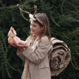 Child holding the OLLI ELLA Dinky Dinkum Dolls - Scottie Snail - Orange