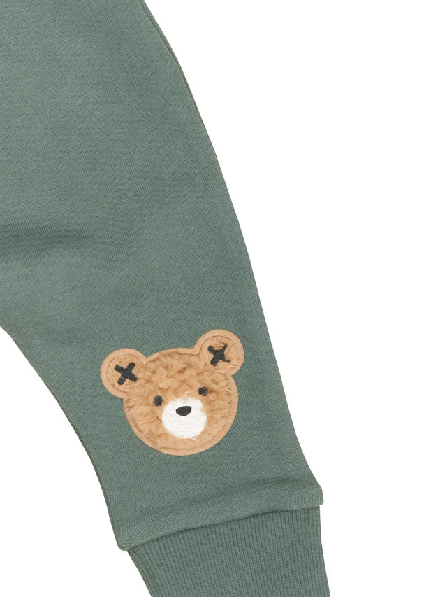 Detail view of Huxbear knee patch on the HUXBABY Light Spruce Furry Huxbear Drop Crotch Pant