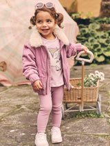 Child wearing the HUXBABY Orchid Rib Legging and matching cord jacket
