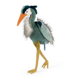 Stuffed bird toy with a green body, orange beak, and yellow legs on a white background