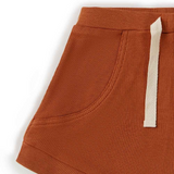Close-up of a ribbed brown shorts with a drawstring on a white background