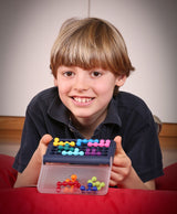 Child playing with SMART GAMES IQ FIT