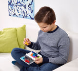 Child playing with SMART GAMES IQ XOXO