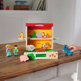 Children's toy set with farm animals and figures on a wooden surface
