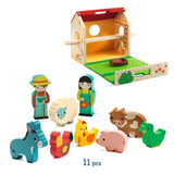 Wooden toy set with a barn, farmer, animals, and other figures on a white background.
