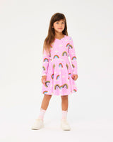 Girl wearing ROCK YOUR BABY SOMEWHERE OVER THE RAINBOW LONG SLEEVE WAISTED DRESS