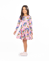 Studio shot of girl wearing ROCK YOUR BABY UNICORN DAISY LONG SLEEVE WAISTED DRESS