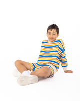 Boy sitting on ground wearing ROCK YOUR BABY VINTAGE STRIPE SWEATSHIRT and matching shorts
