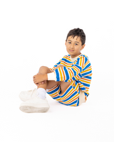 Boy sitting on ground wearing ROCK YOUR BABY VINTAGE STRIPE SWEATSHIRT and matching shorts