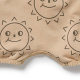Beige fabric with smiley sun designs on a white background