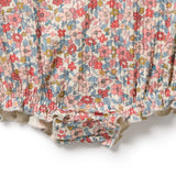 Floral-patterned fabric with pink, red, and blue flowers on a white background