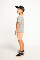 Side view of boy wearing MUNSTER KIDS Windswell Short - Light Pink