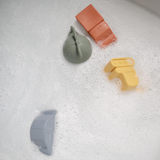 Bath toys floating in the soapy water