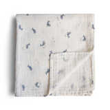 Folded fabric with blue whale pattern on a white background