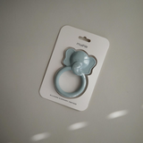 Silicone elephant teether packaged in a Mushie branded card against a neutral background