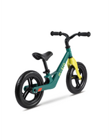 Green and yellow balance bike on a white background