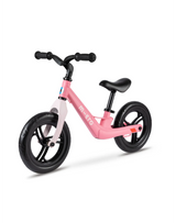Pink balance bike with black wheels on a white background