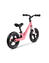 Pink balance bike on a white background